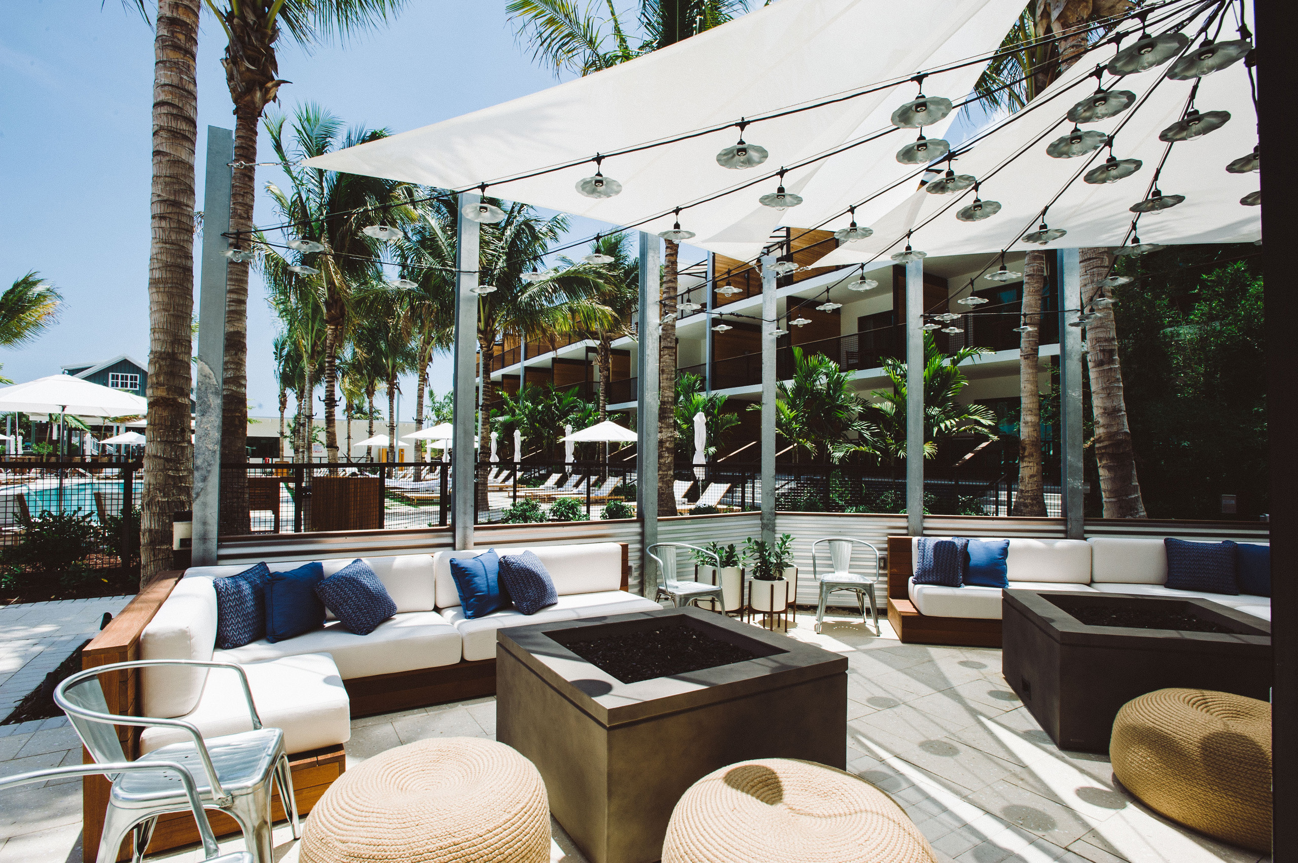 Outdoor lounge with sofas and string lights.