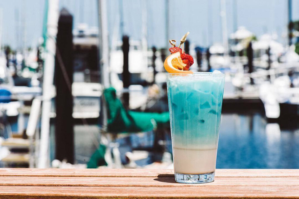 Blue cocktail by marina with fruit garnish.