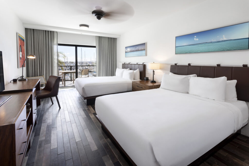 Accessible guest room with two queen beds and marina view balcony.