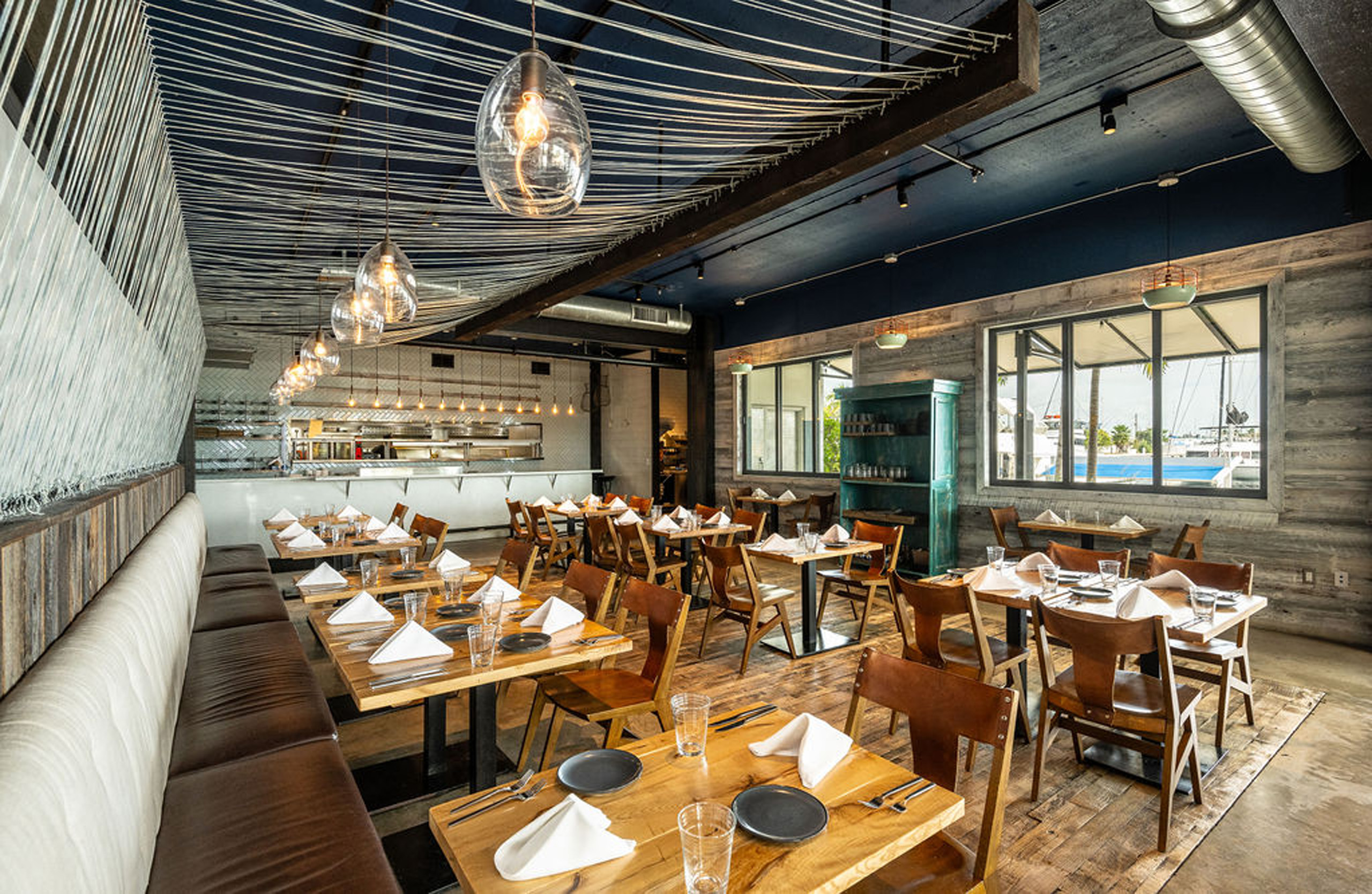 Modern rustic dining room with open kitchen view.