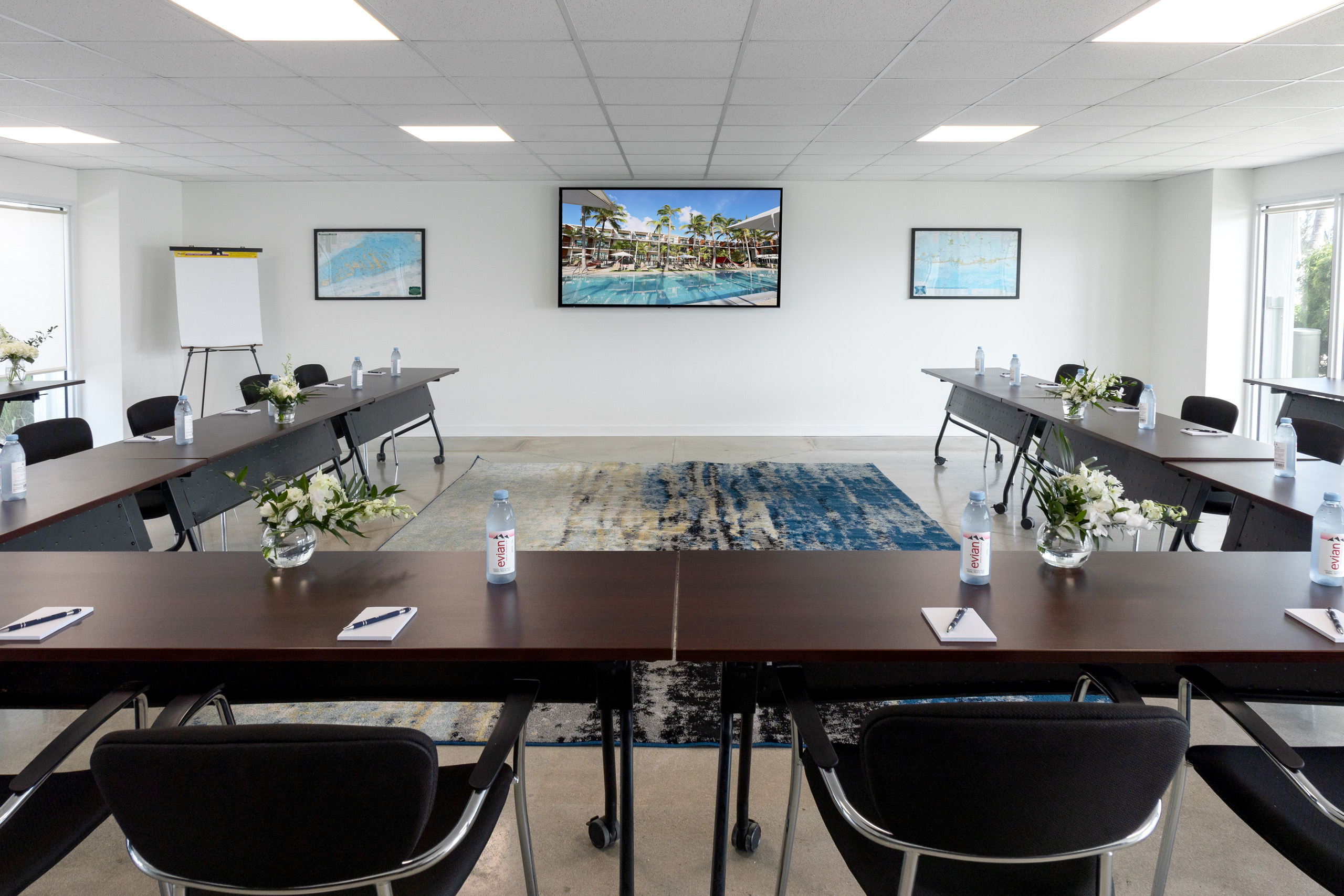 Spacious conference room with natural light and presentation screen.
