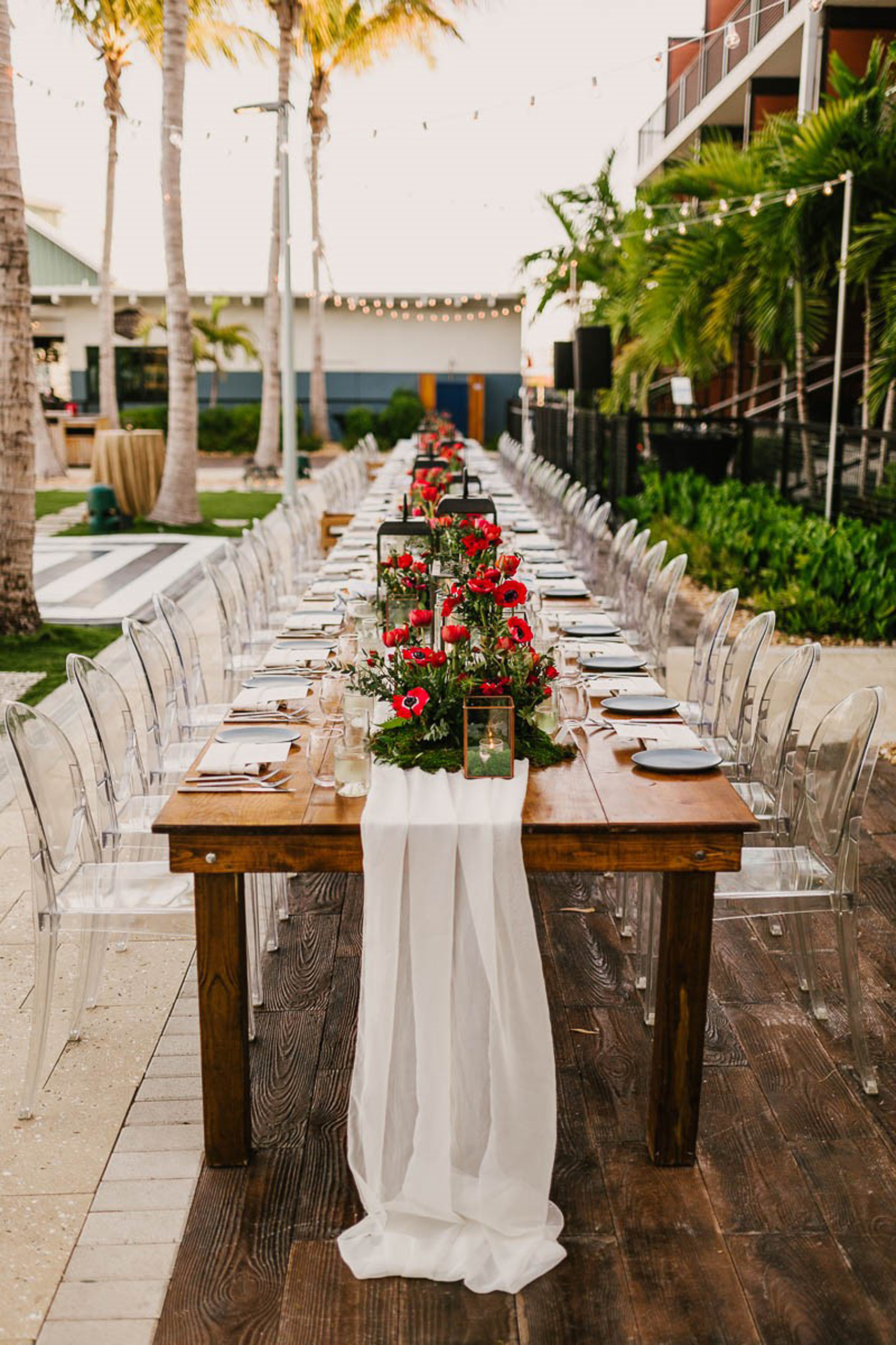 Elegant outdoor wedding reception setup by poolside.