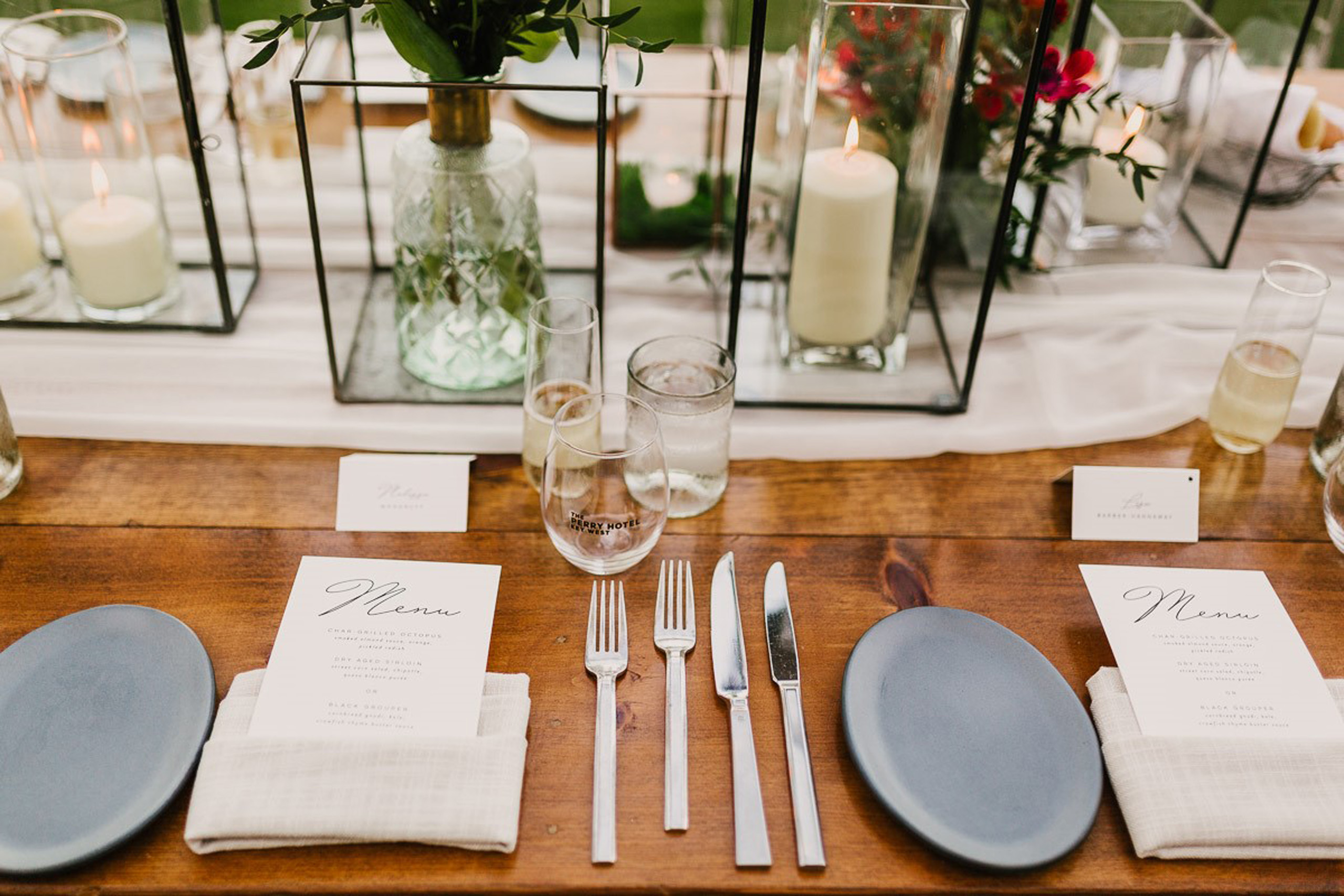 Table setting with candles and floral centerpiece.