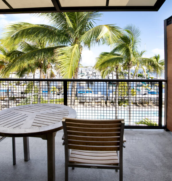 Modern king bedroom with seating and balcony access.