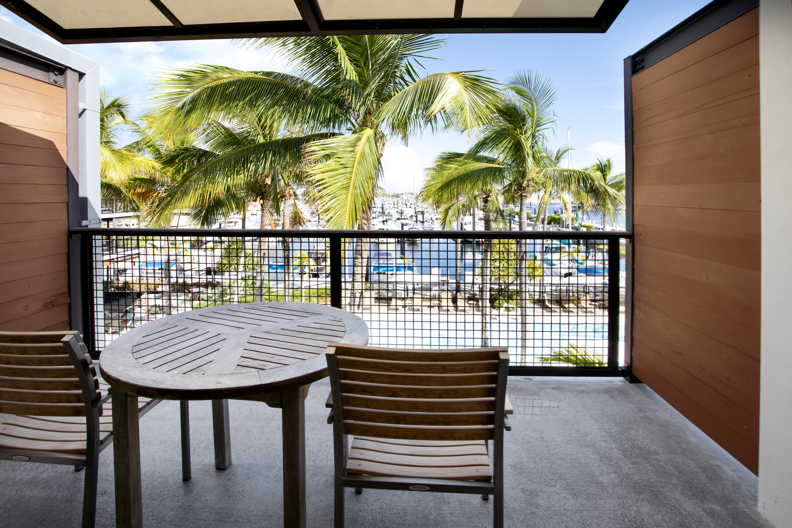 Modern king bedroom with seating and balcony access.