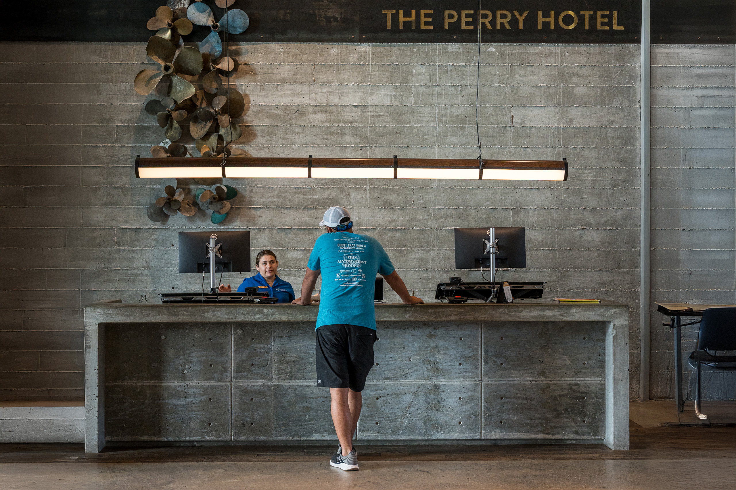 Guest at front desk of The Perry Hotel.