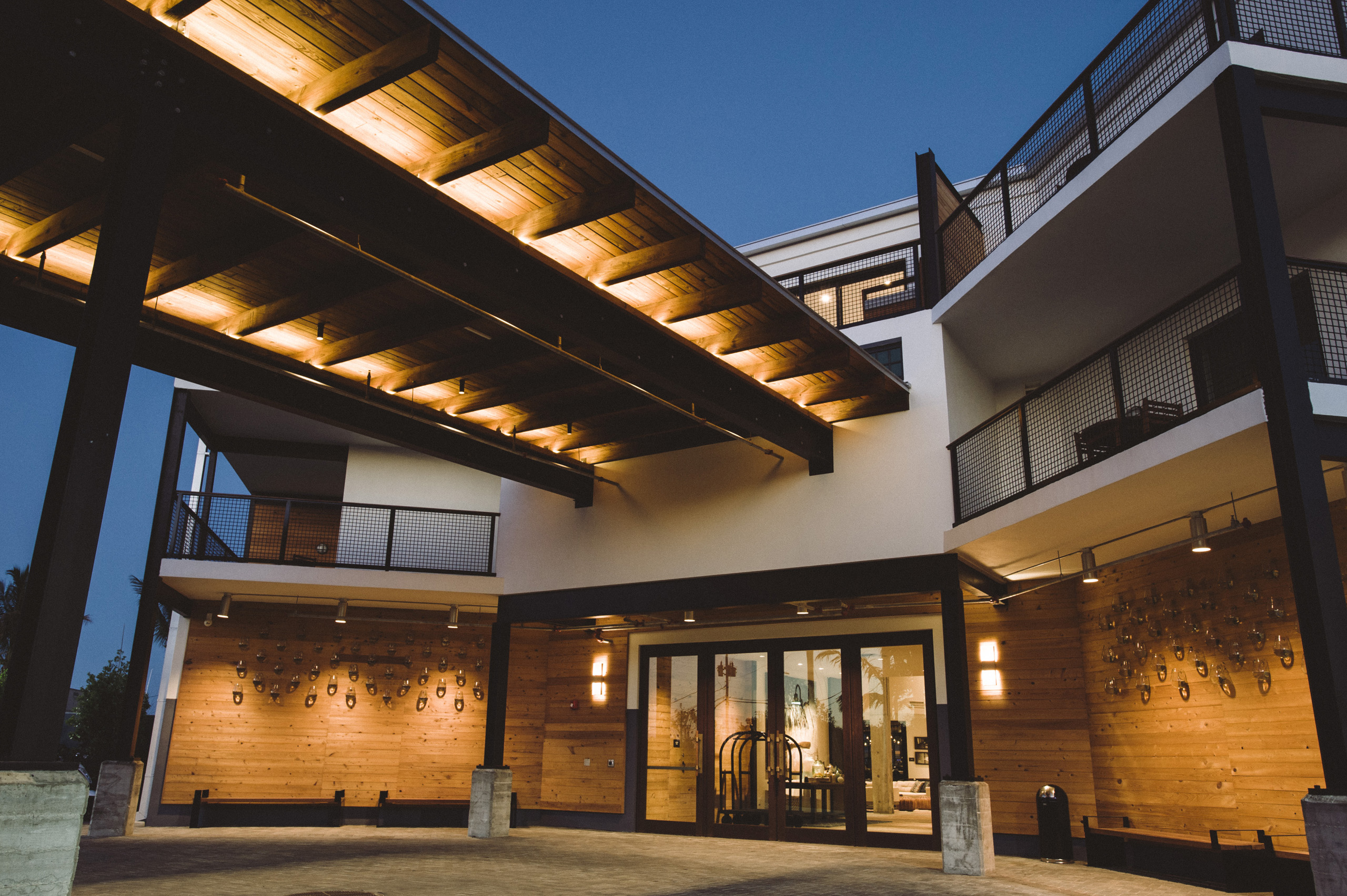 Hotel entrance with modern lighting and wood accents.