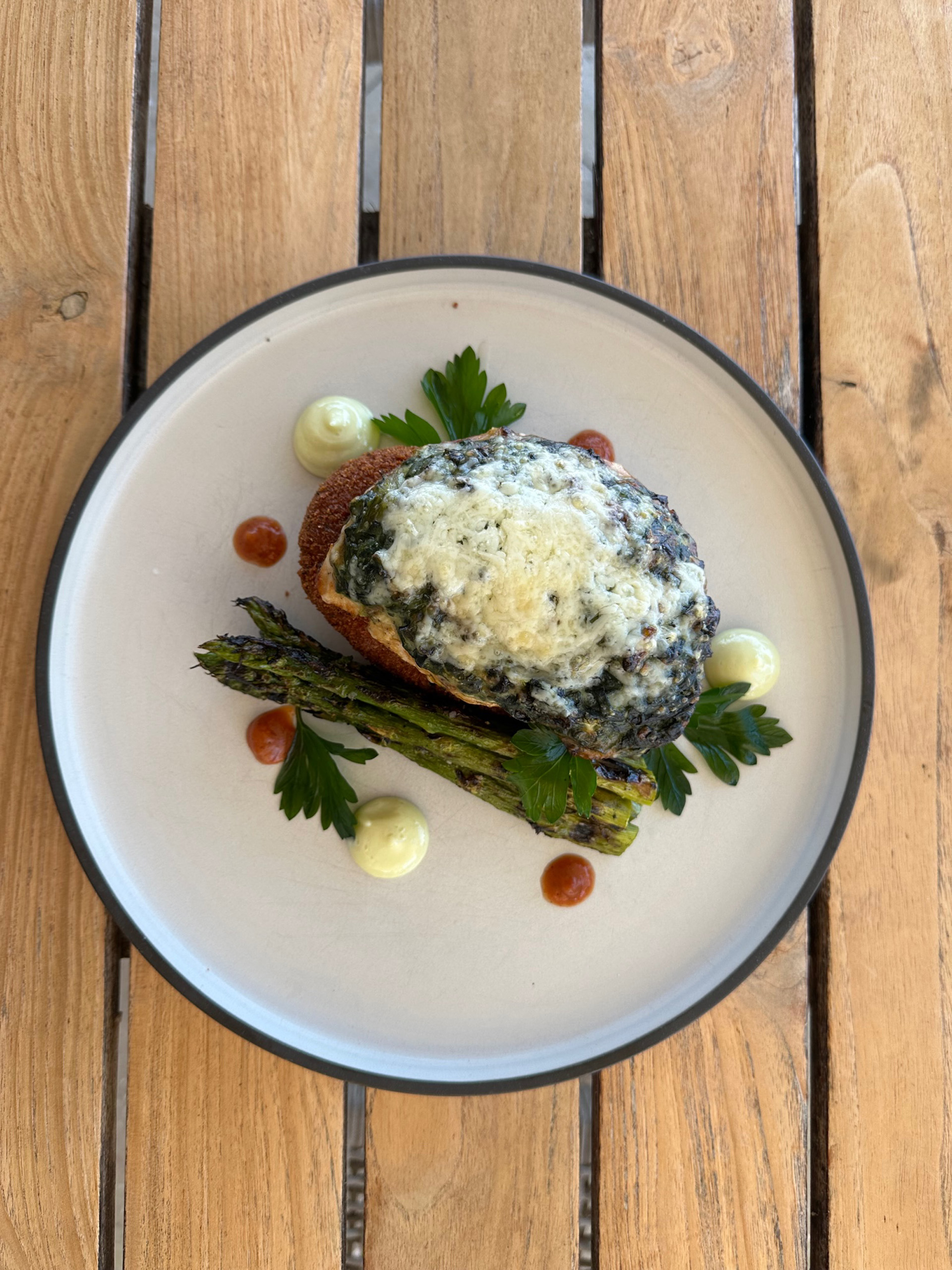 Crab-crusted steak topped with asparagus and creamy sauce.